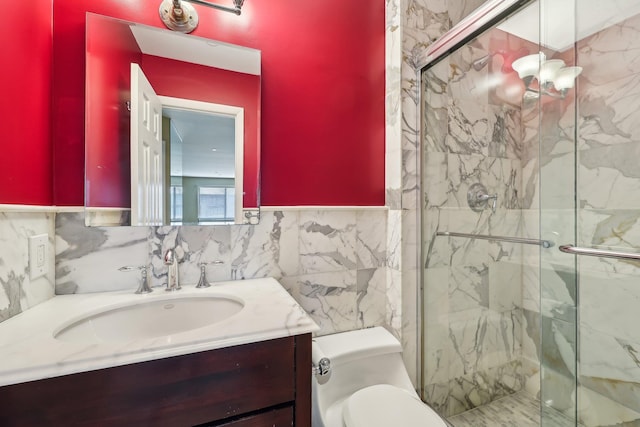 full bathroom featuring a marble finish shower, toilet, vanity, and tile walls