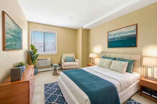 bedroom featuring a baseboard heating unit, carpet, and an AC wall unit