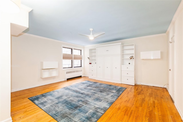 entryway with light wood finished floors, radiator heating unit, a ceiling fan, and crown molding