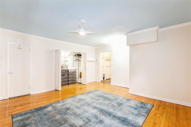 unfurnished bedroom with ornamental molding, ceiling fan, baseboards, and wood finished floors