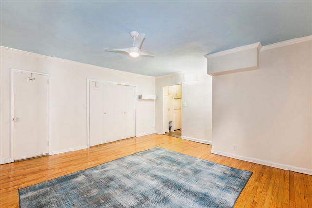 unfurnished bedroom with ornamental molding, hardwood / wood-style floors, and baseboards