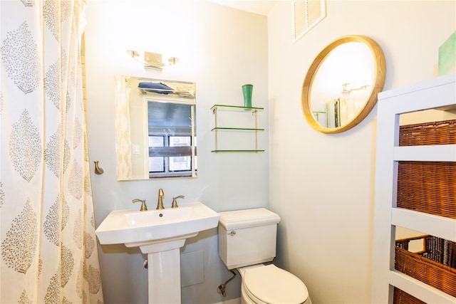 full bath featuring toilet and visible vents