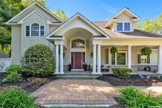 view of front of property with covered porch and stone siding