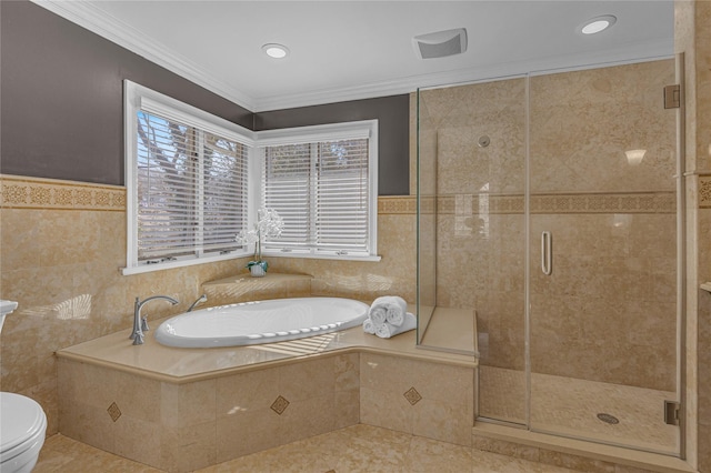 bathroom with a bath, a shower stall, tile walls, and crown molding