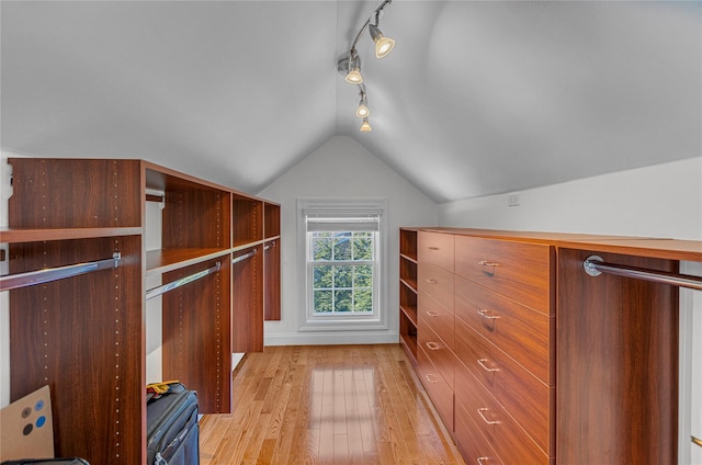 walk in closet with lofted ceiling and light wood-style flooring