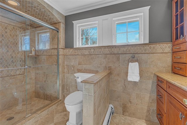 full bathroom with toilet, a baseboard radiator, ornamental molding, a shower stall, and tile walls