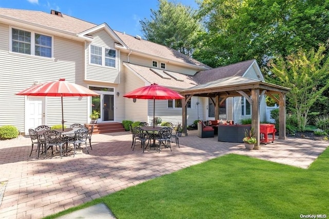 back of house featuring entry steps, a patio, a gazebo, outdoor lounge area, and outdoor dining space