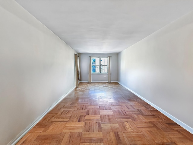 empty room featuring baseboards