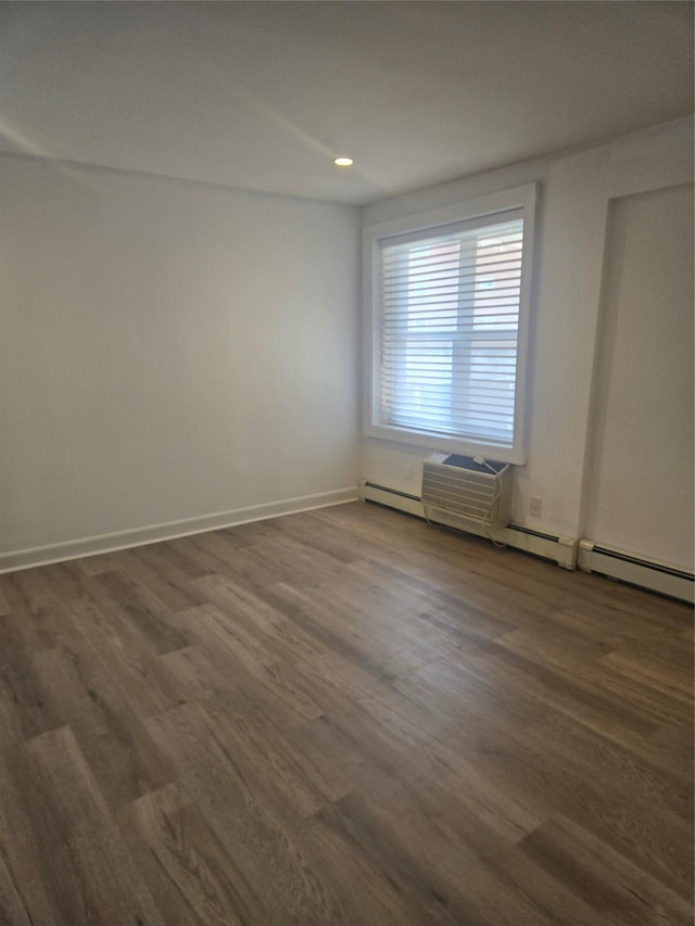 spare room with dark wood-style floors and baseboards