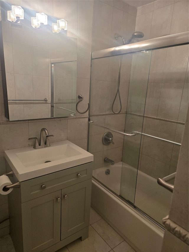 bathroom featuring tile walls, backsplash, combined bath / shower with glass door, vanity, and tile patterned flooring