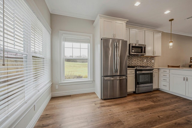 4109 Fox Hill Dr Unit 4109, Baiting Hollow, NY 11933 - kitchen featuring backsplash, dark wood-type flooring, stainless steel appliances, and crown molding