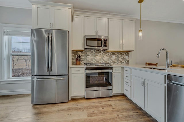 4109 Fox Hill Dr Unit 4109, Baiting Hollow, NY 11933 - kitchen featuring stainless steel appliances, light countertops, decorative backsplash, ornamental molding, and a sink
