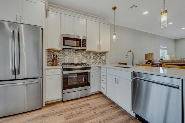 4109 Fox Hill Dr Unit 4109, Baiting Hollow, NY 11933 - kitchen featuring light countertops, visible vents, light wood-style flooring, appliances with stainless steel finishes, and a sink