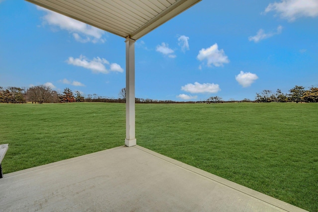 view of yard with a rural view and a patio