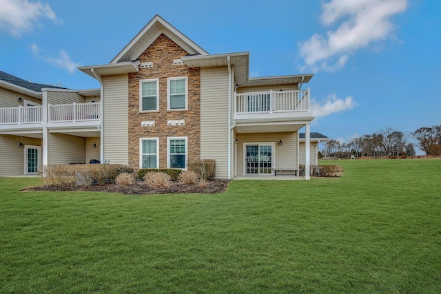 4109 Fox Hill Dr Unit 4109, Baiting Hollow, NY 11933 - back of house featuring a balcony, stone siding, and a yard