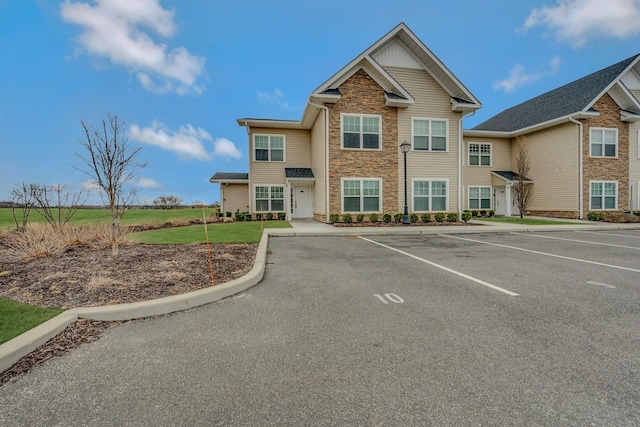 4109 Fox Hill Dr Unit 4109, Baiting Hollow, NY 11933 - view of front of property featuring stone siding, uncovered parking, and a front lawn