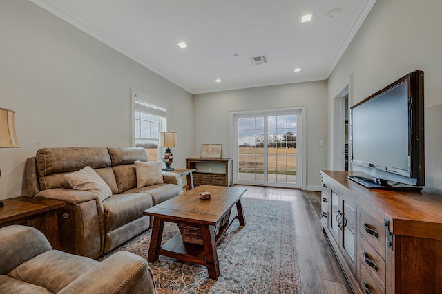 living area featuring recessed lighting, wood finished floors, visible vents, and crown molding