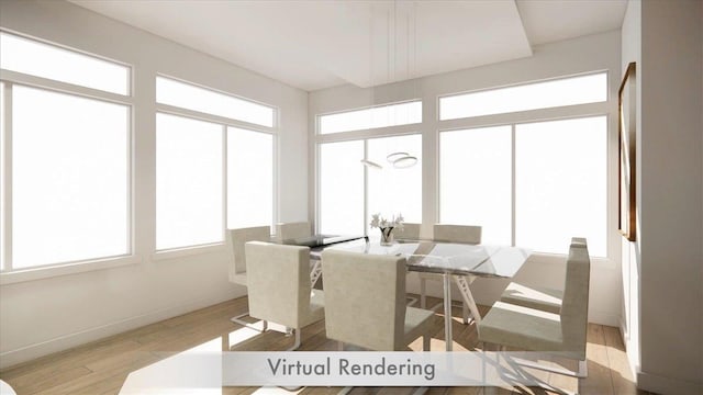 dining area featuring light wood-style flooring and baseboards