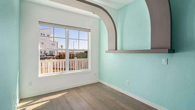 empty room with wood finished floors and baseboards