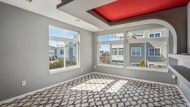 unfurnished sunroom with a raised ceiling