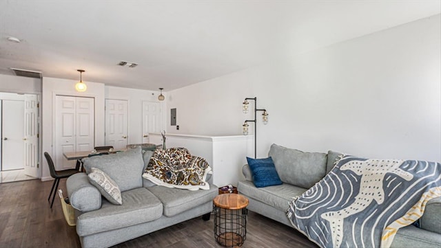 living area with wood finished floors and visible vents