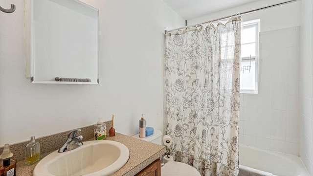 bathroom with shower / bath combination with curtain, vanity, and toilet