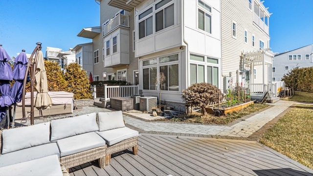 exterior space featuring a jacuzzi, an outdoor hangout area, a wooden deck, a residential view, and a pergola