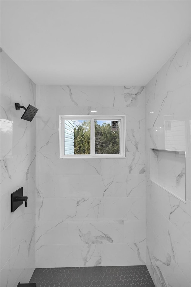 full bathroom with a marble finish shower