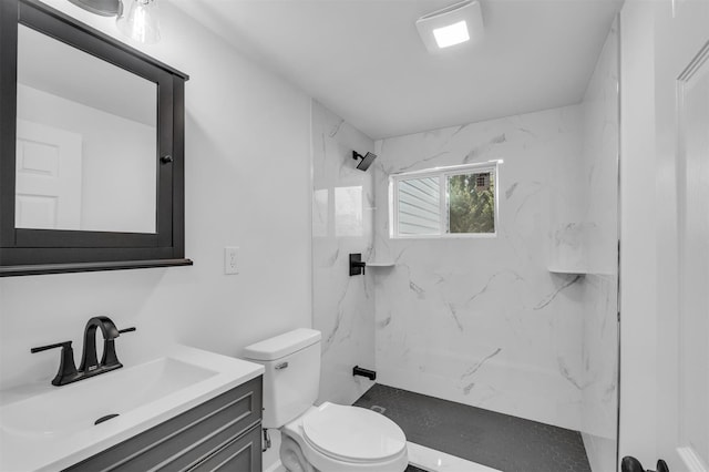 full bath featuring a marble finish shower, toilet, and vanity