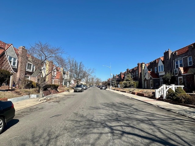 view of road featuring a residential view, curbs, and sidewalks