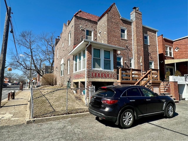 view of front of property with fence and brick siding