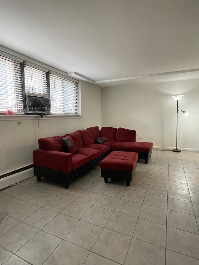 living area with a baseboard radiator, light tile patterned flooring, and baseboards