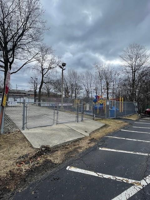 view of sport court with a gate and fence