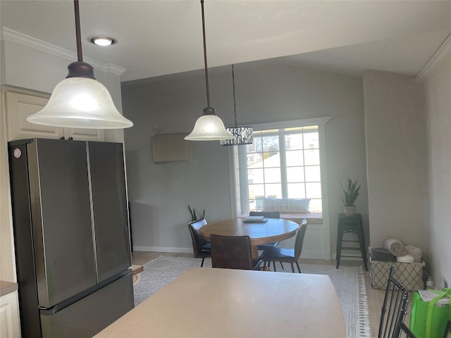 dining space featuring ornamental molding and baseboards