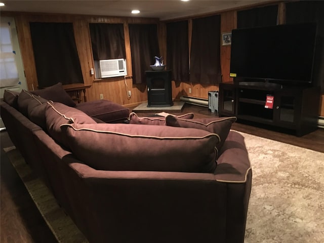 living room with a baseboard heating unit, recessed lighting, cooling unit, and wooden walls