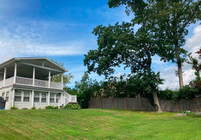 view of yard featuring stairs and fence