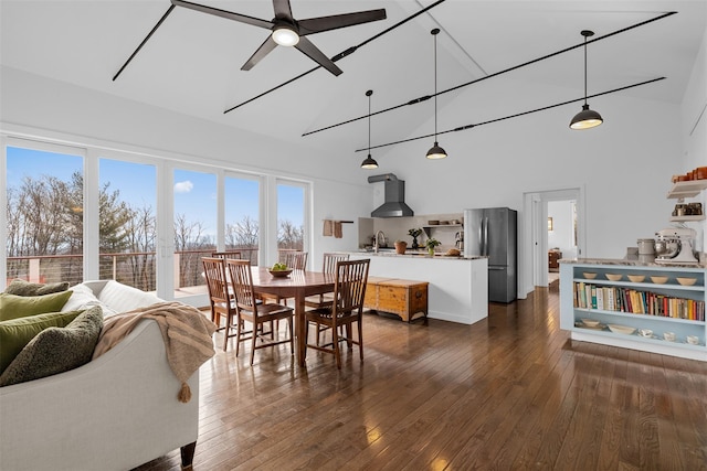 dining space featuring high vaulted ceiling, dark wood finished floors, and ceiling fan