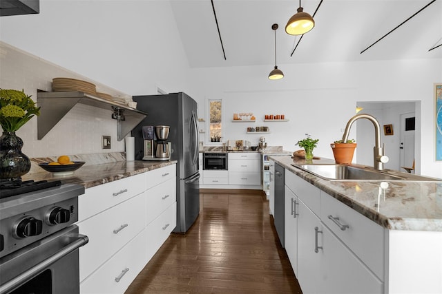 kitchen with a sink, white cabinets, appliances with stainless steel finishes, open shelves, and dark wood finished floors