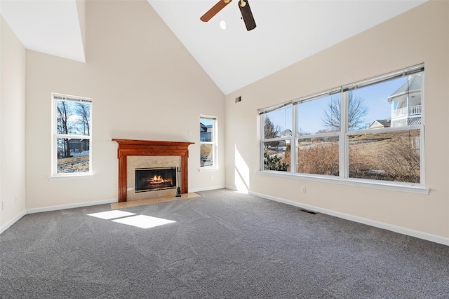 unfurnished living room featuring baseboards, visible vents, carpet floors, a fireplace, and high vaulted ceiling