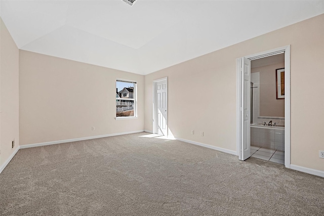 unfurnished bedroom with carpet, connected bathroom, and baseboards