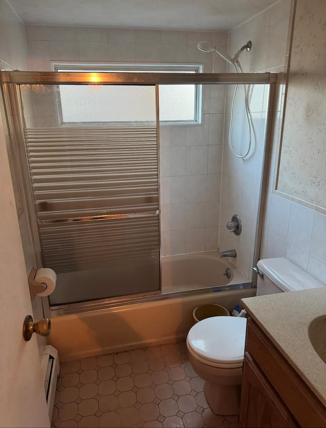 bathroom with toilet, radiator, a baseboard radiator, combined bath / shower with glass door, and vanity