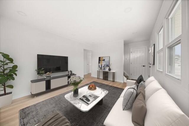 living area featuring stairway and wood finished floors