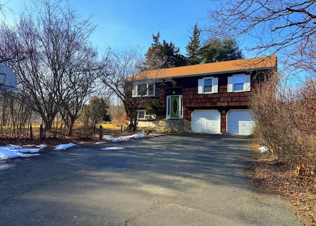 bi-level home featuring driveway and an attached garage