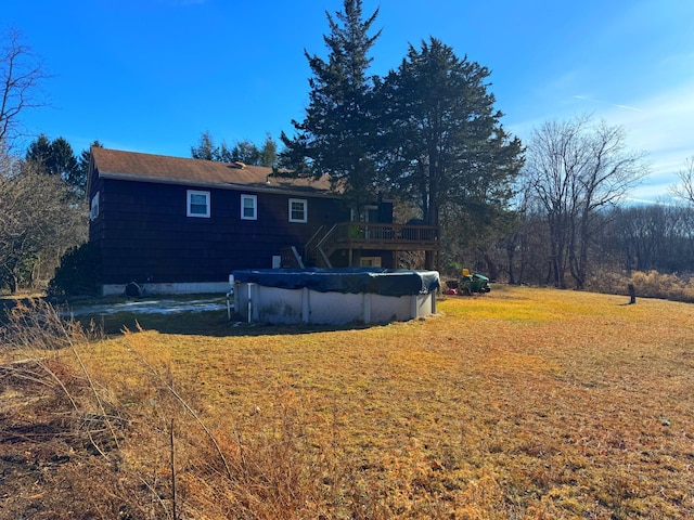 view of yard with a covered pool and a wooden deck