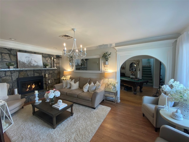 living room with crown molding, arched walkways, pool table, wood finished floors, and visible vents
