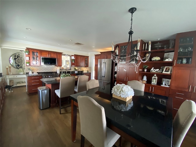 dining room featuring a chandelier, dark wood finished floors, recessed lighting, visible vents, and ornamental molding