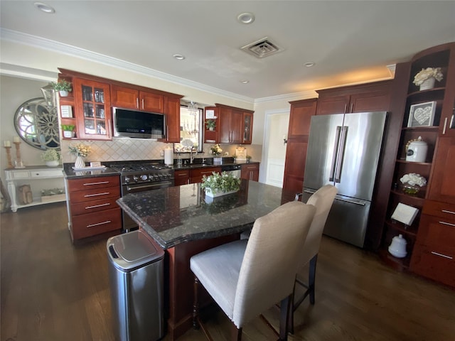kitchen with open shelves, ornamental molding, high end appliances, a sink, and dark wood finished floors