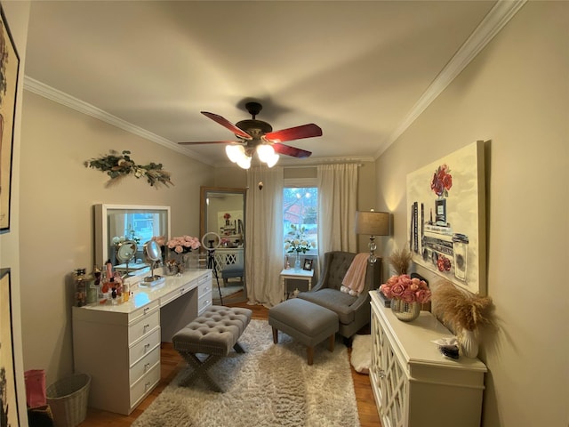 living area featuring crown molding, a ceiling fan, and wood finished floors