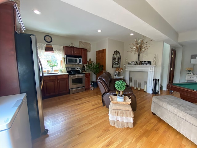 living area with recessed lighting and light wood-style flooring