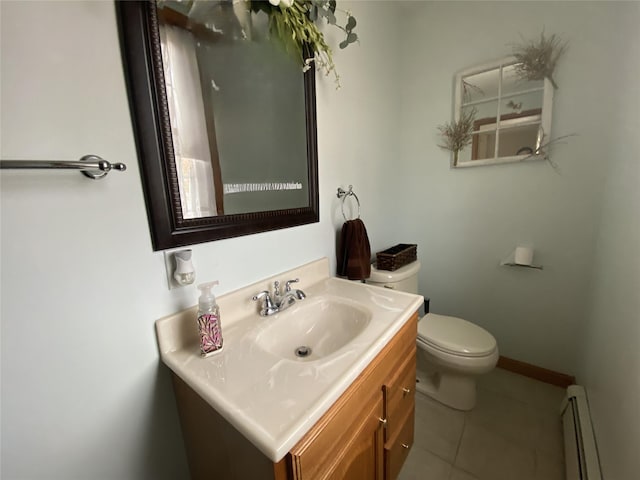 bathroom featuring tile patterned flooring, vanity, toilet, baseboards, and a baseboard heating unit